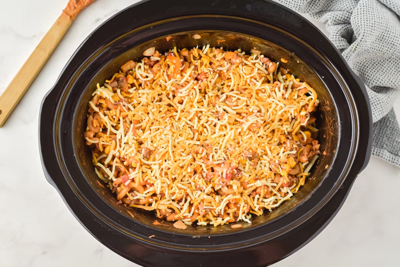 cheese on top of ground beef casserole in crockpot