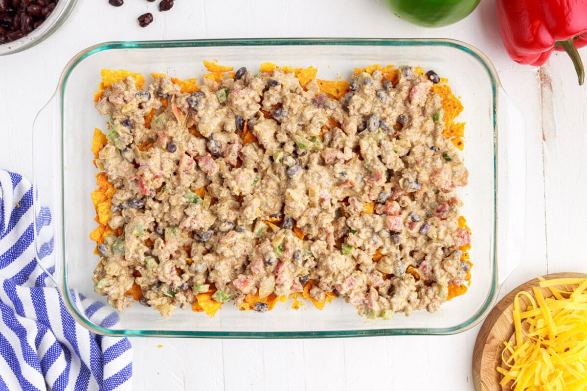 ground beef mixture over crushed doritos