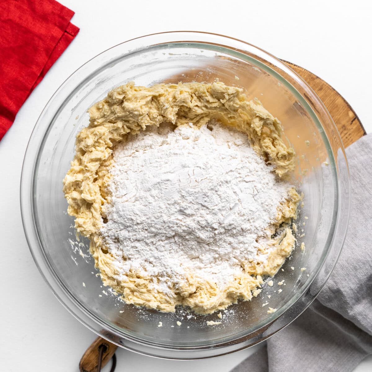 flour on top of cookie dough in a bowl