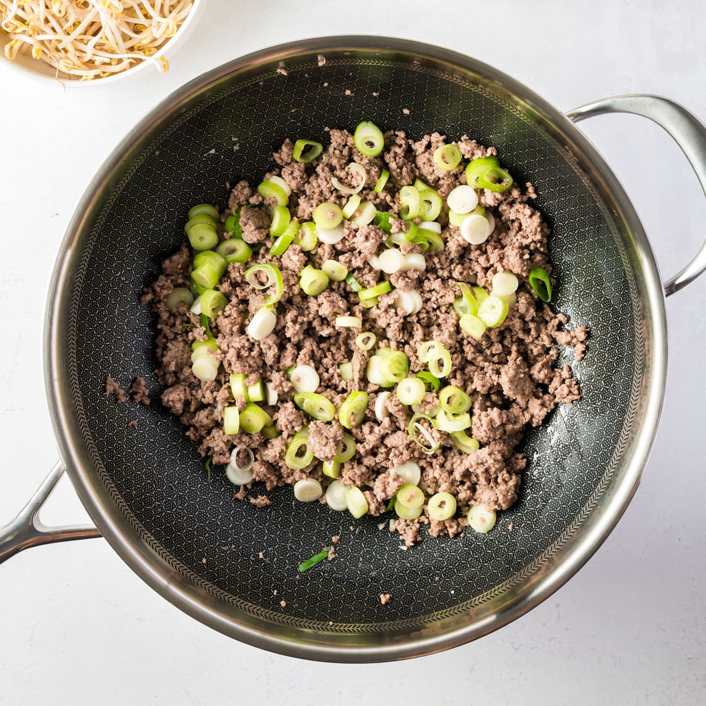 ground beef, spring onions, and garlic in a skillet