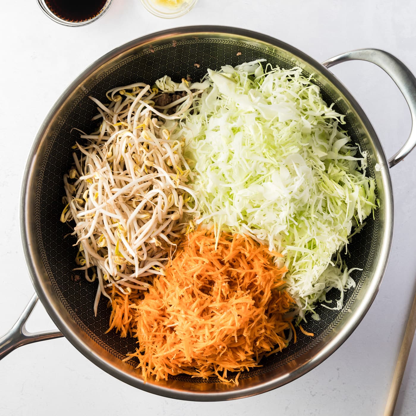 cabbage, carrots, and mung bean sprouts in a skillet