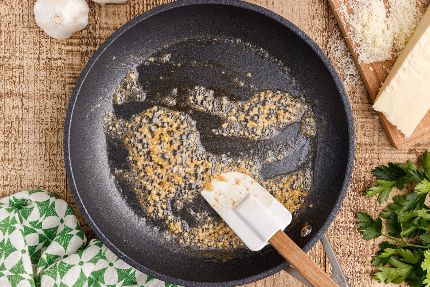 sauteeing minced garlic in a skillet