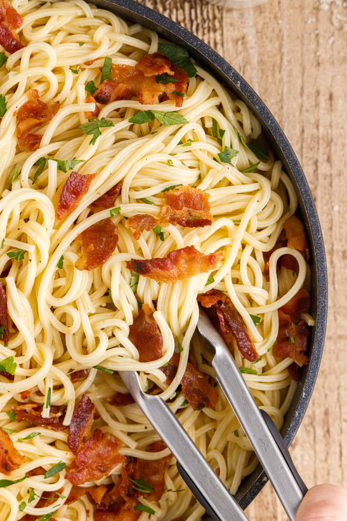 Pasta Carbonara with tongs