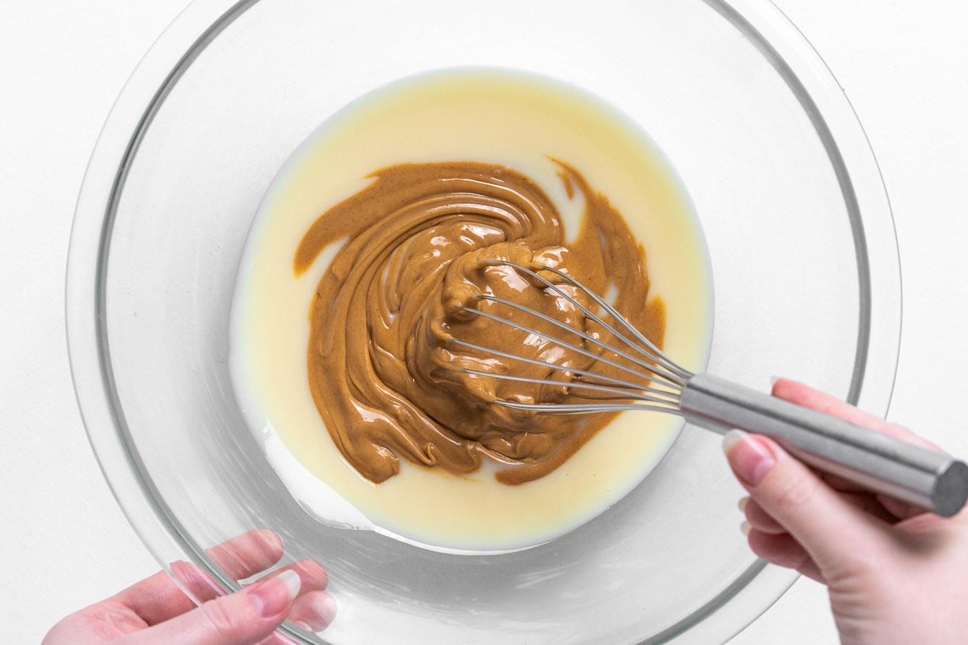 whisking peanut butter and sweetened condensed milk in a bowl