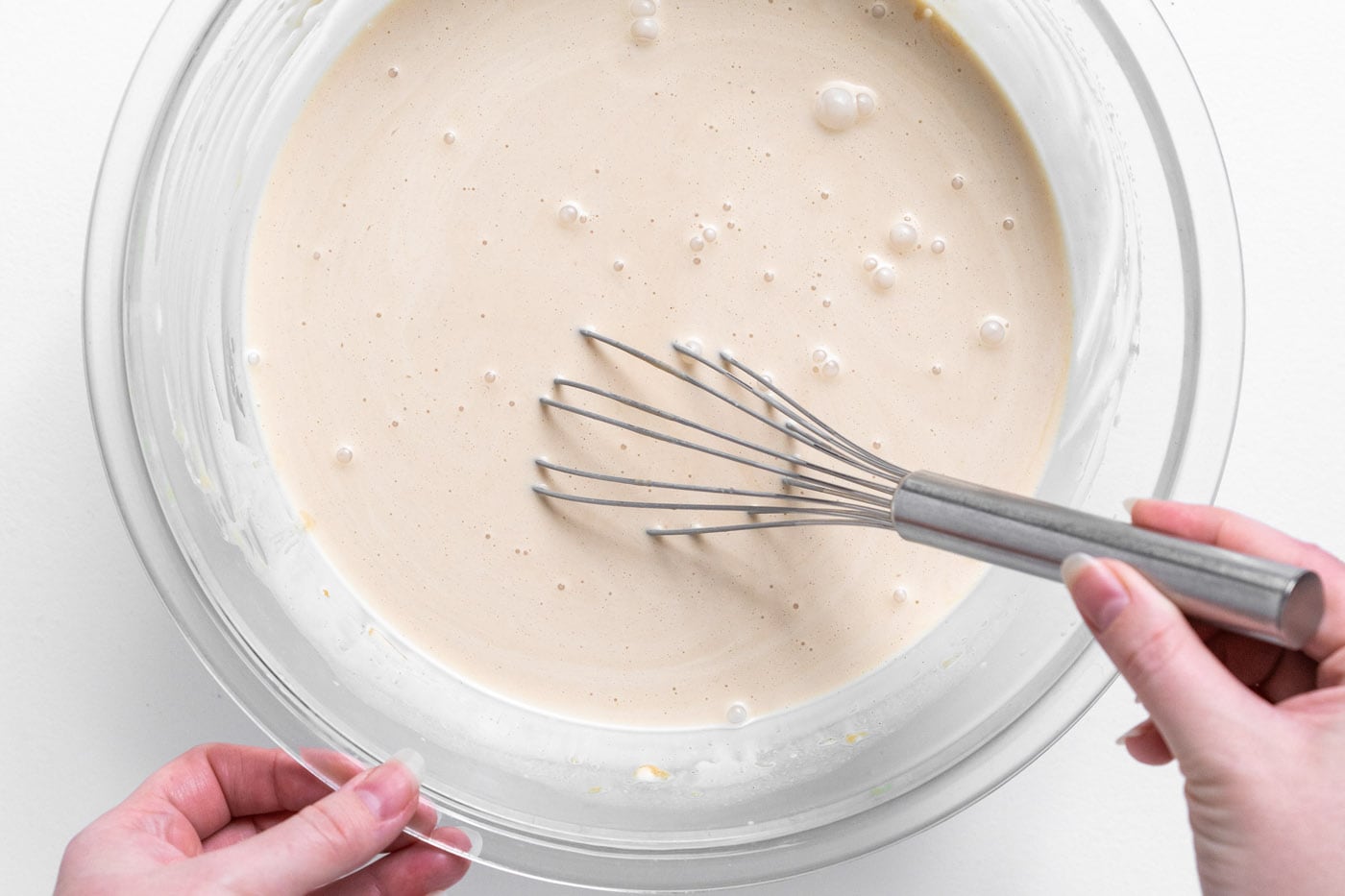 whisking peanut butter ice cream in a bowl
