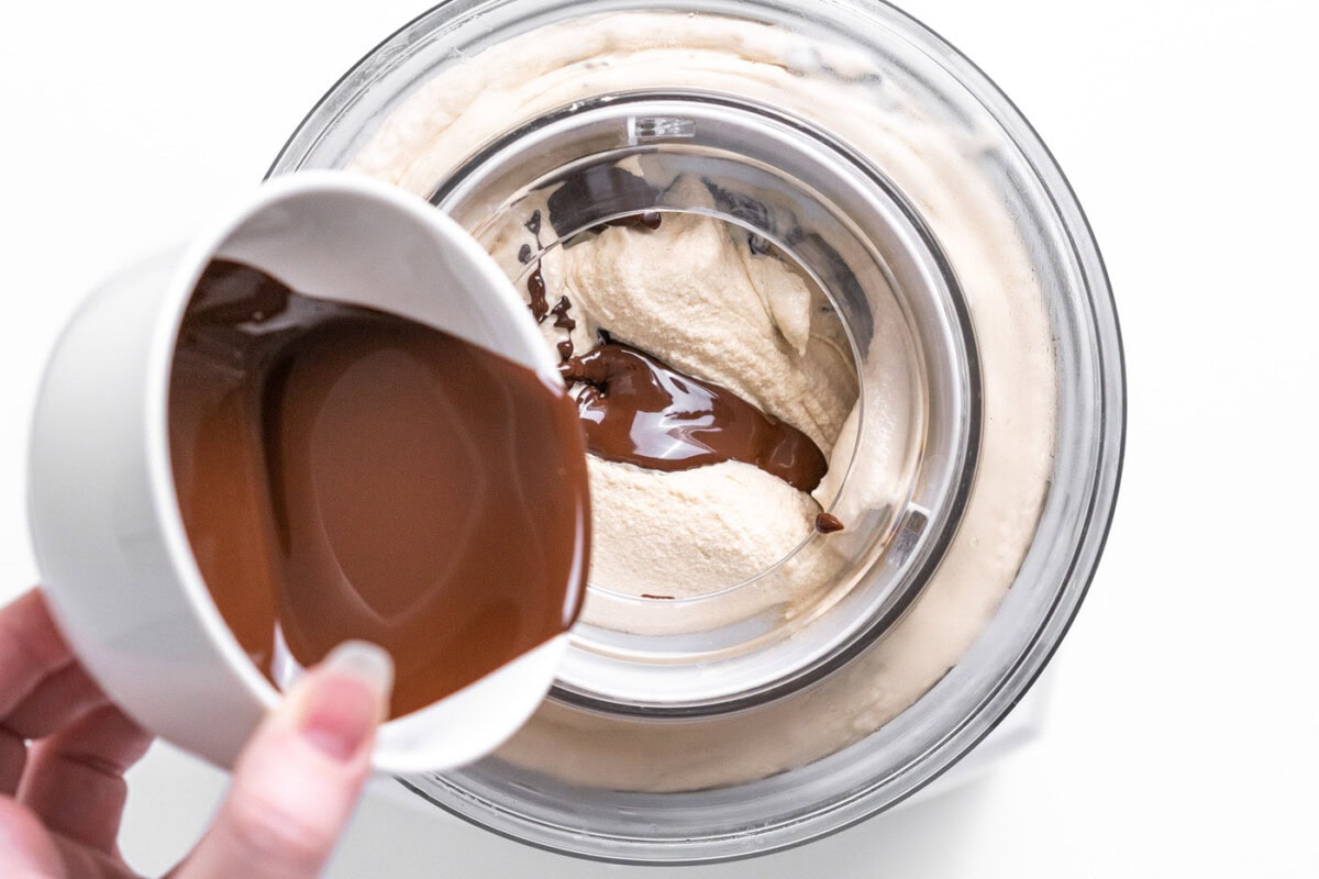 pouring melted chocolate into peanut butter ice cream