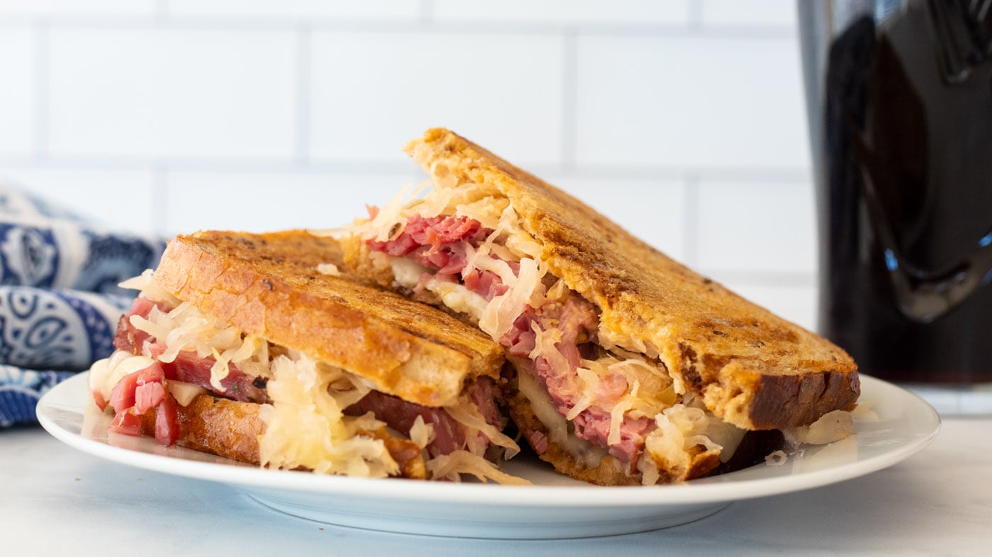 The sweet and sour flavors of corned beef meet tart sauerkraut sandwiched between butter toasted rye