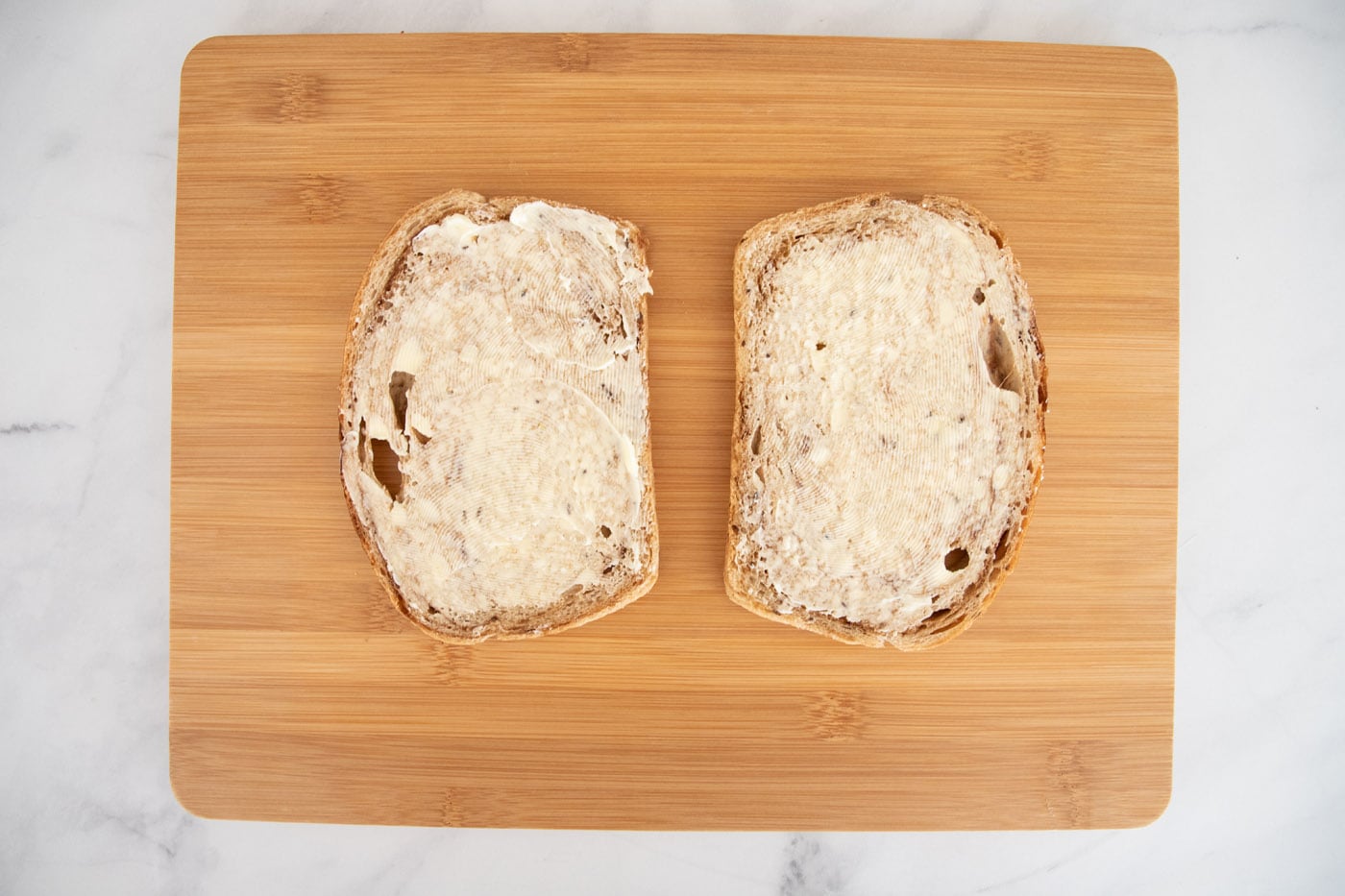 buttered rye bread on cutting board