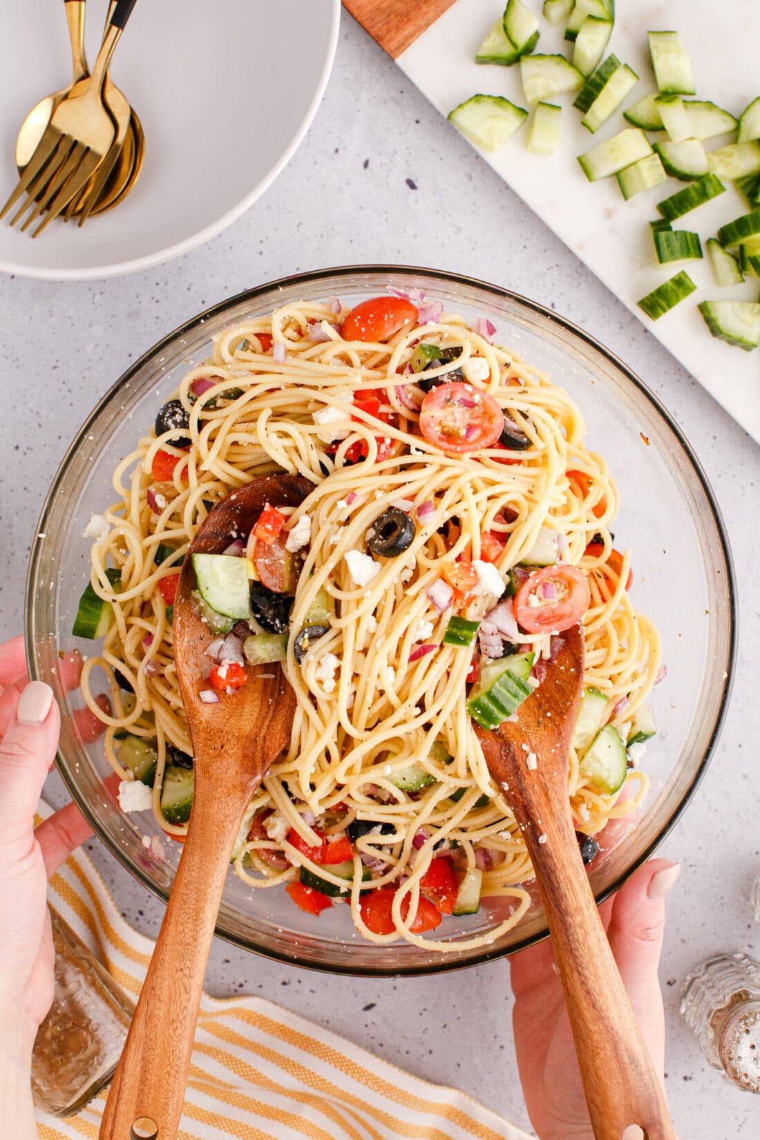 woman mixing a bowl of Spaghetti Salad