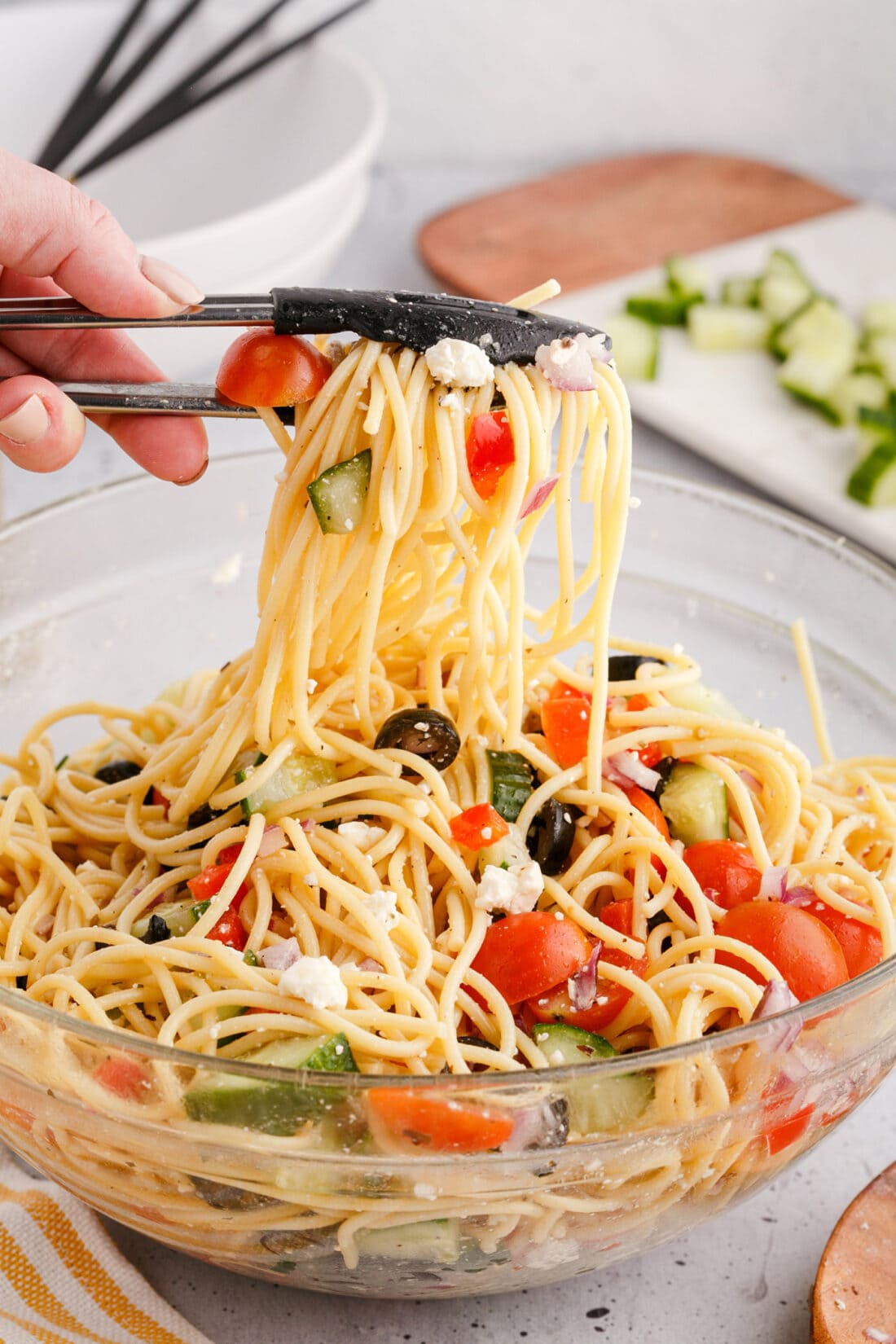 Spaghetti Salad lifted by tongs