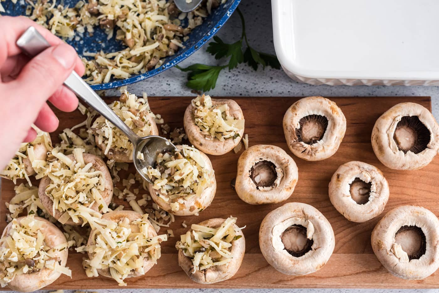 stuffing mushroom caps with cheese mixture