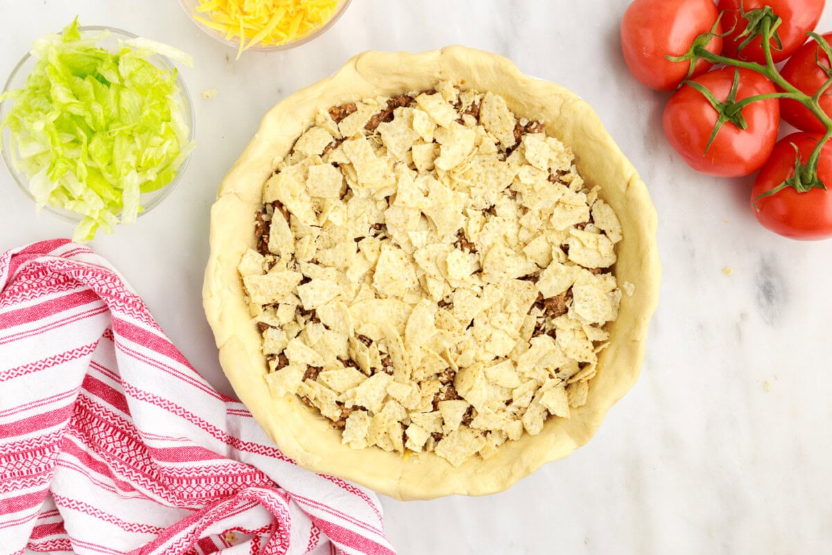 crushed tortilla chips on top of ground beef pie