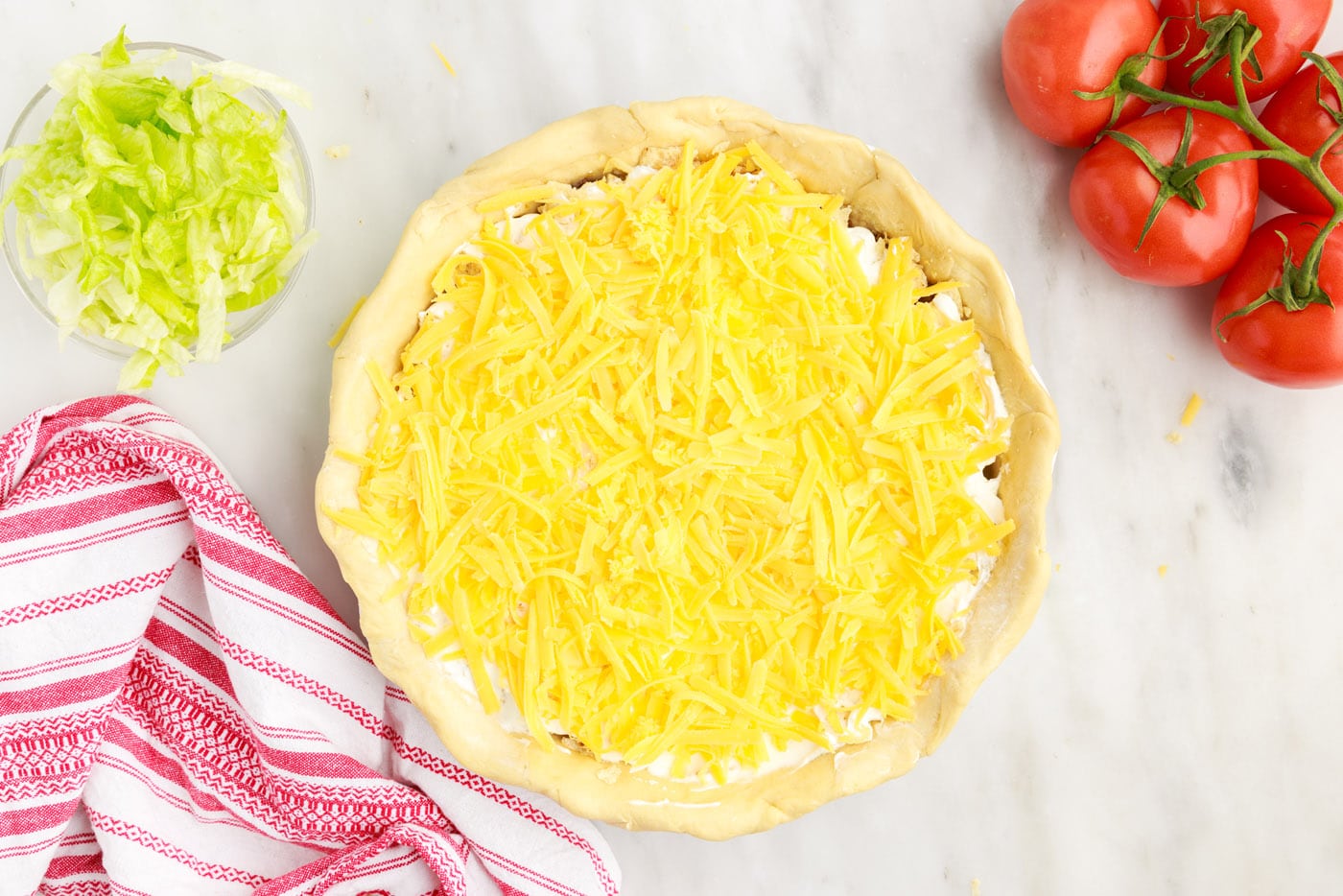 layer of shredded cheese on taco pie
