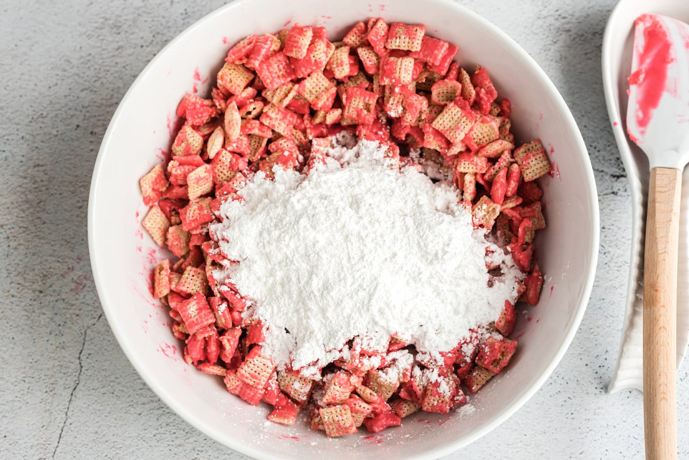 powdered sugar over chocolate coated chex cereal