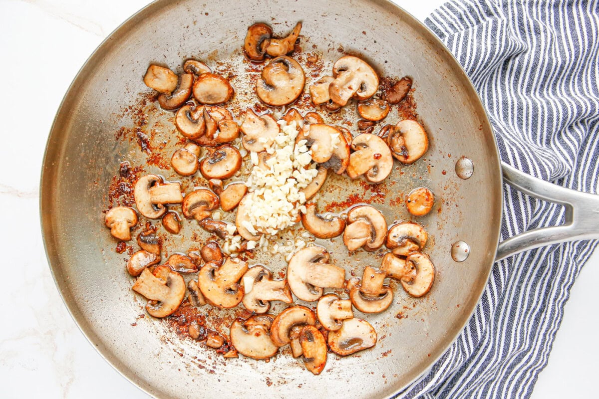mushrooms and minced garlic in a skillet