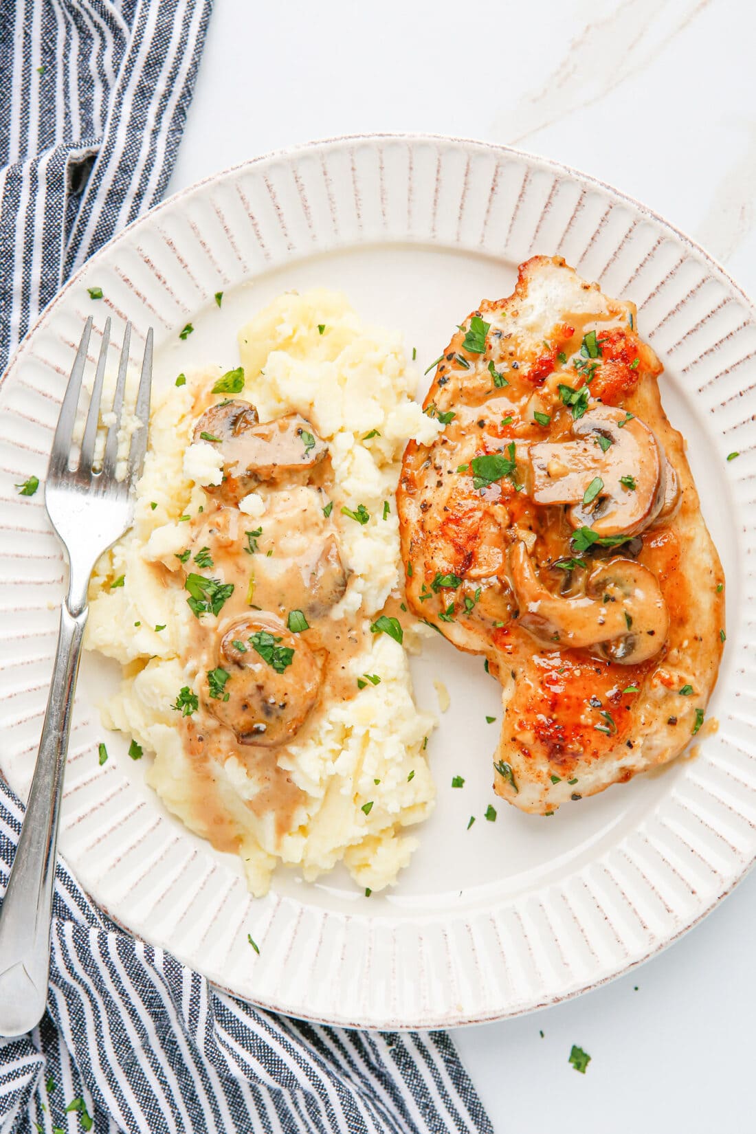 Chicken Marsala on a plate with potatoes