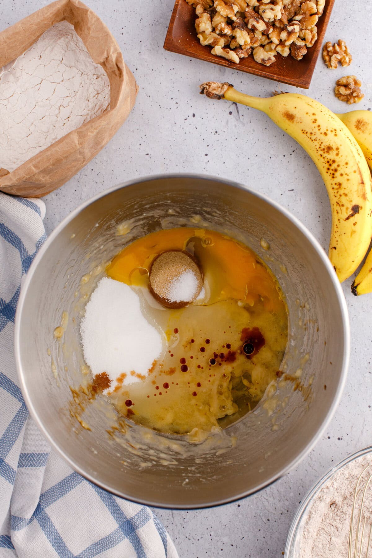 wet ingredients for banana nut bread in a mixing bowl