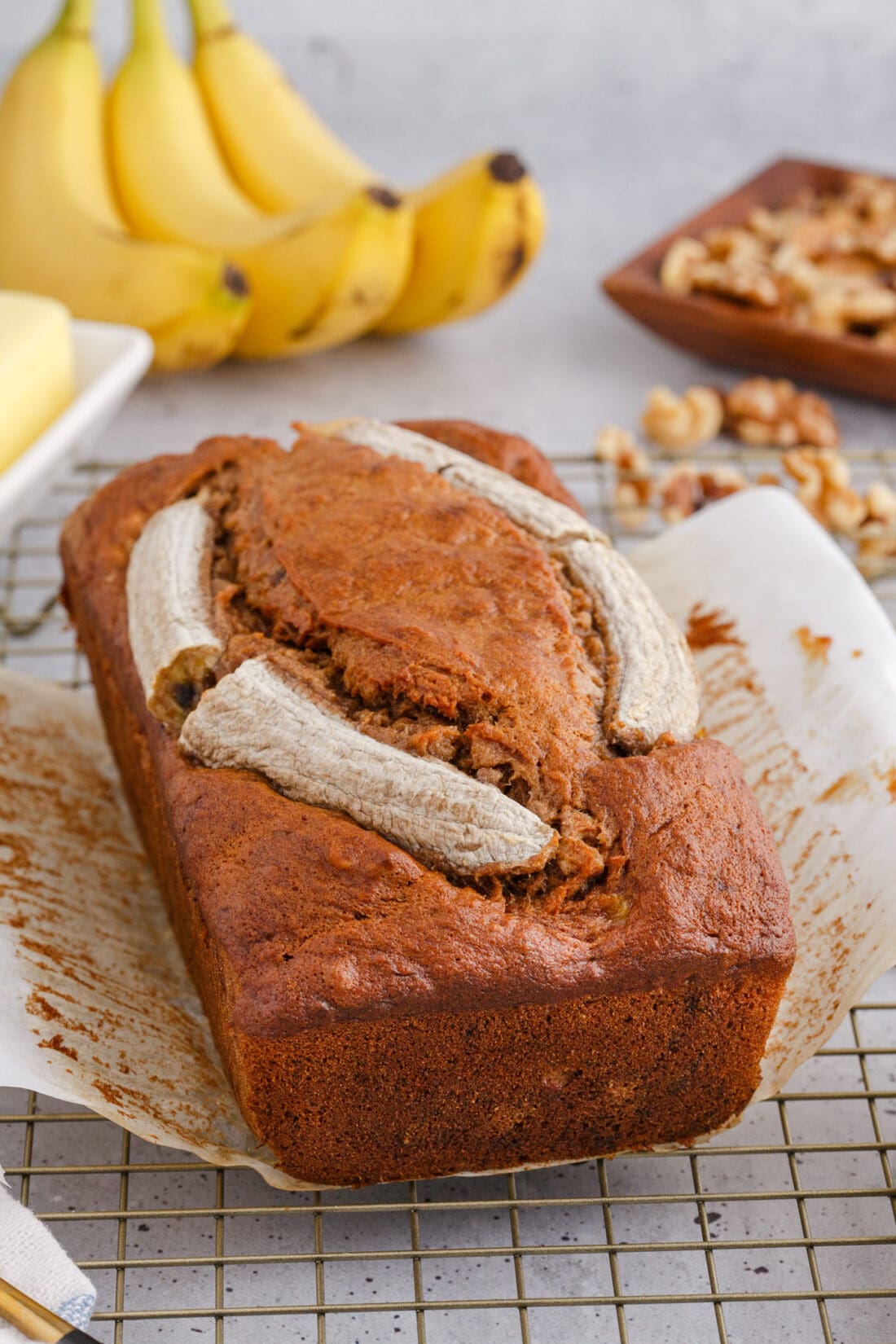 Banana Nut Bread with bananas in the background