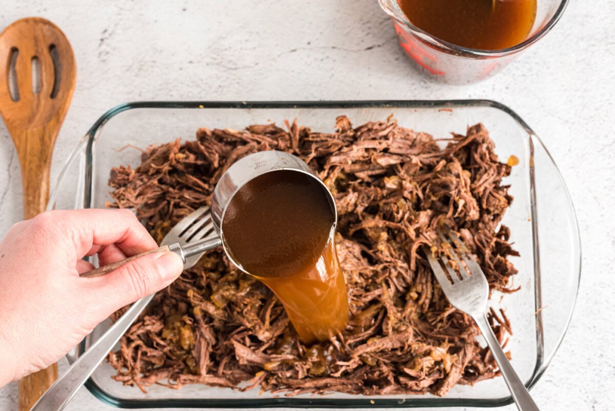 pouring beef juice into chuck roast