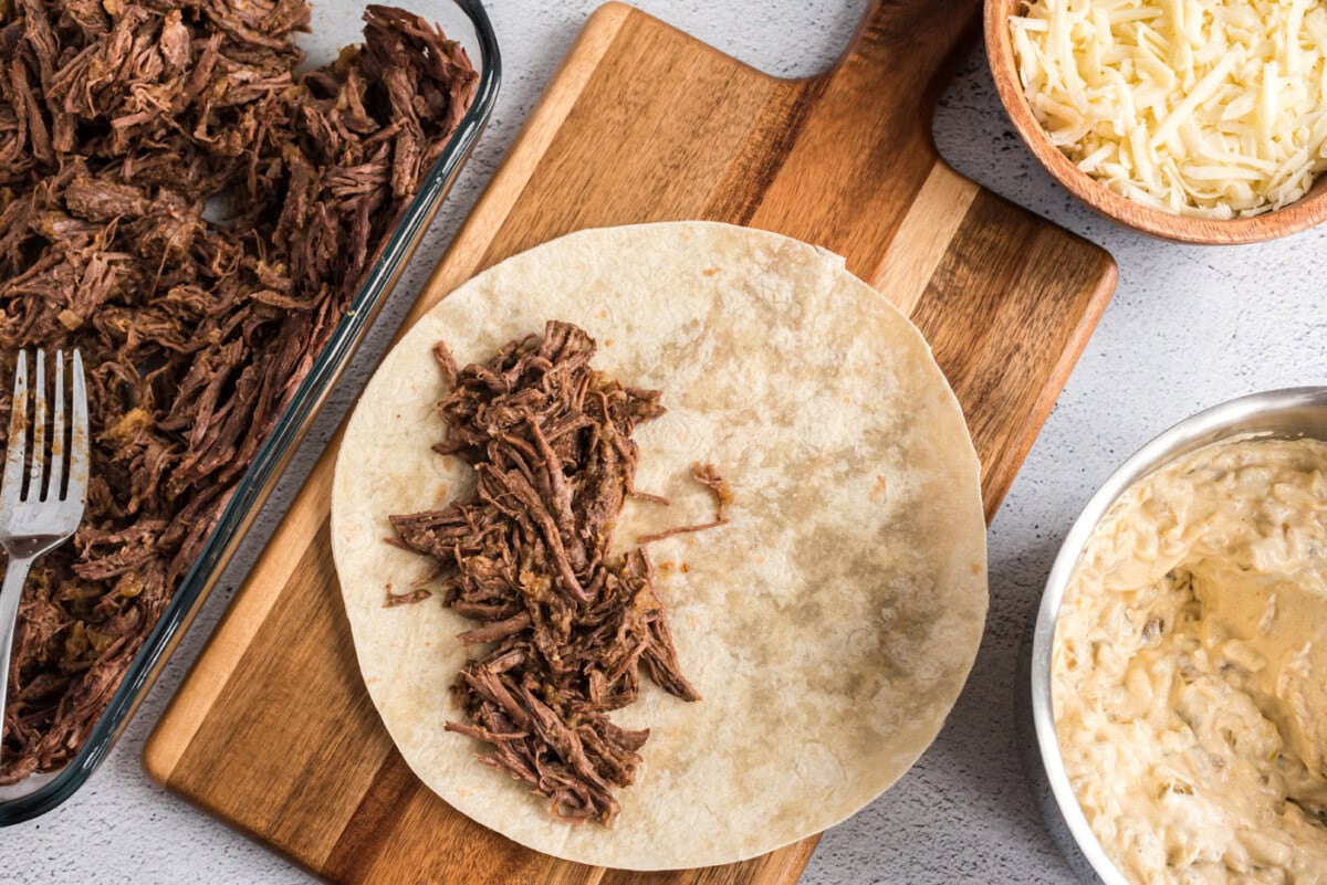 shredded beef on flour tortilla