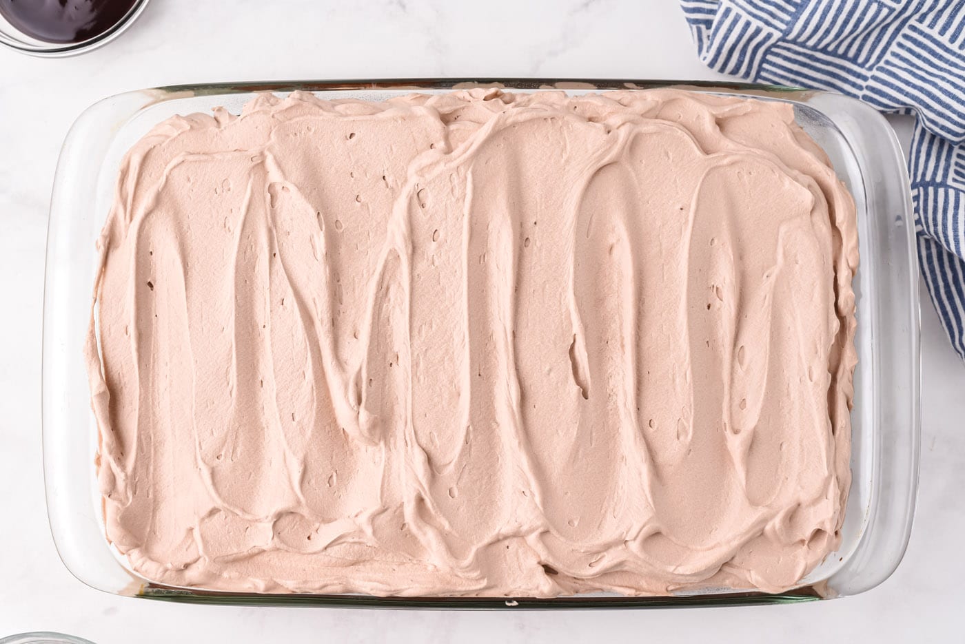 chocolate poke cake with chocolate whipped cream