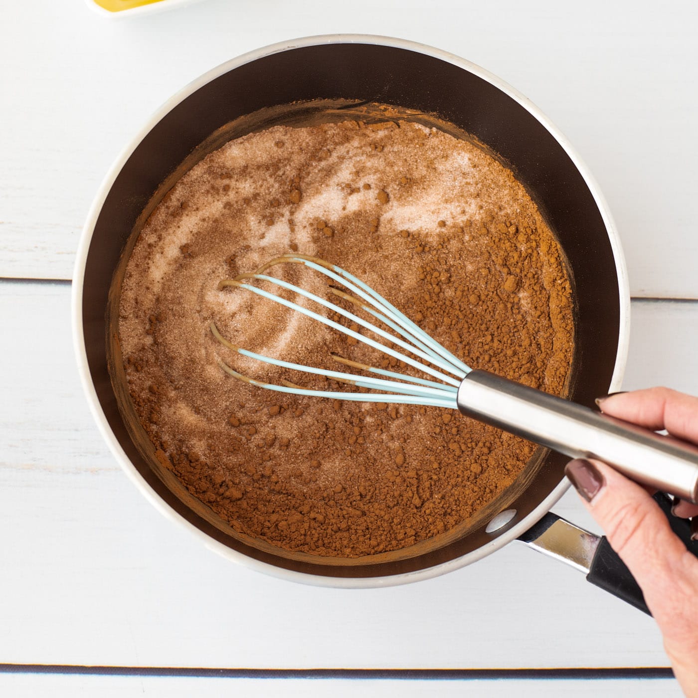 whisking together sugar and cocoa powder