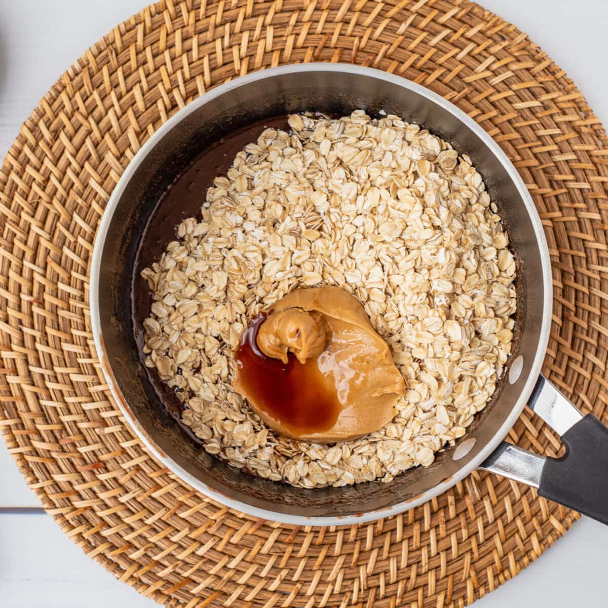 oats, peanut butter, and vanilla over the top of chocolate mixture