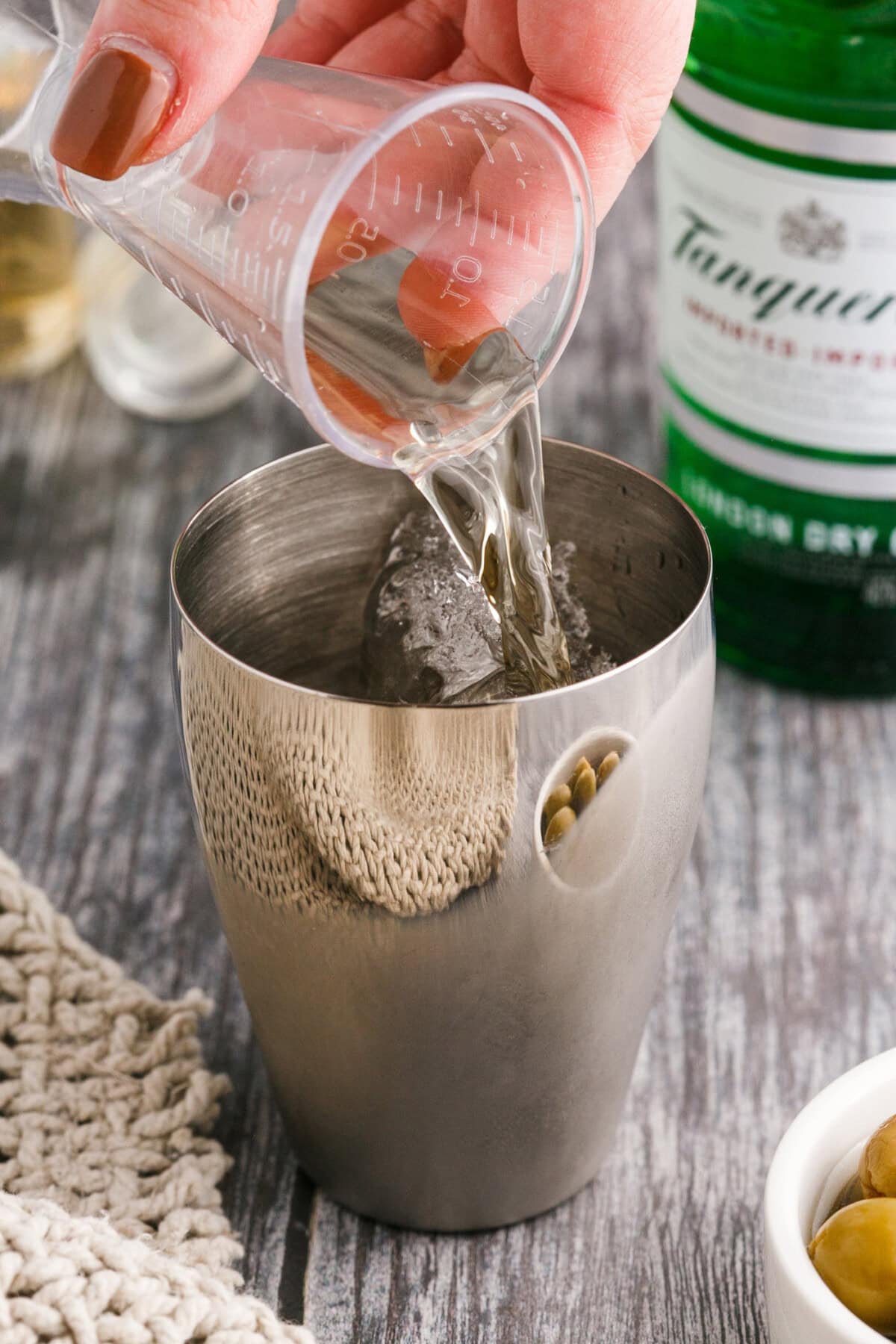pouring gin into cocktail shaker