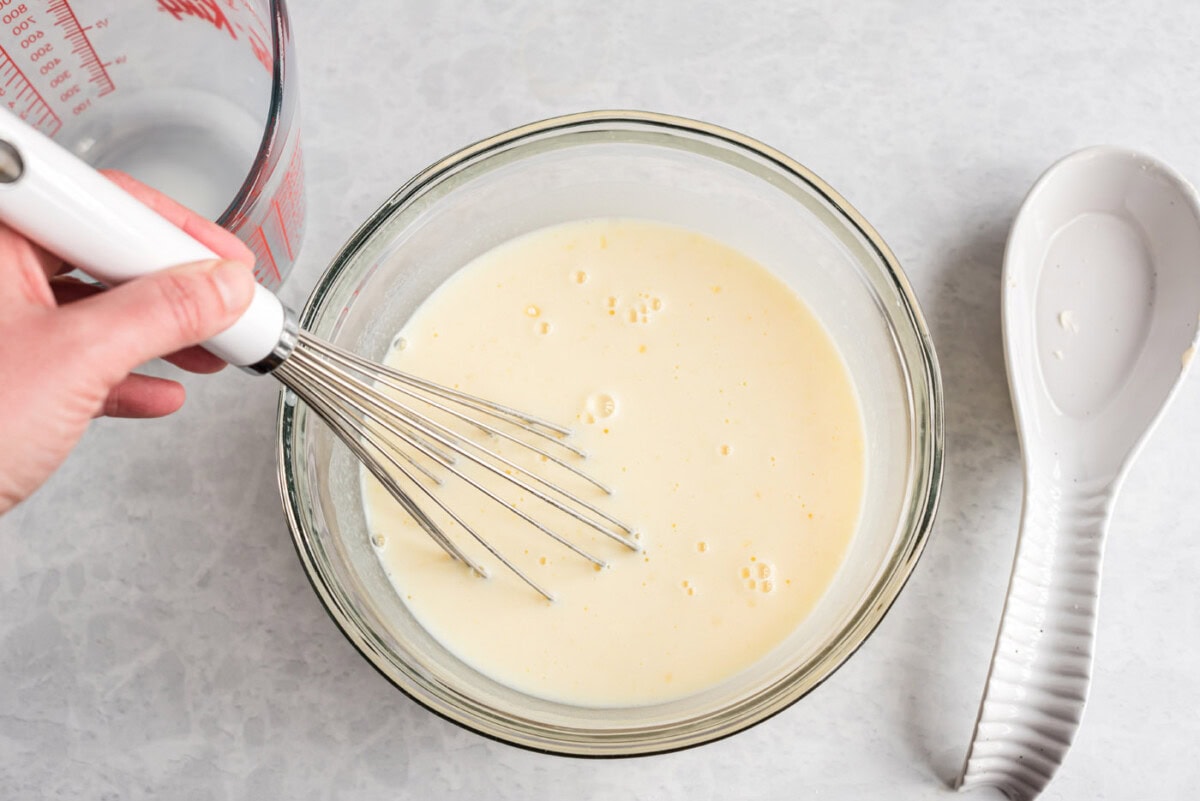 whisking instant vanilla pudding in a bowl