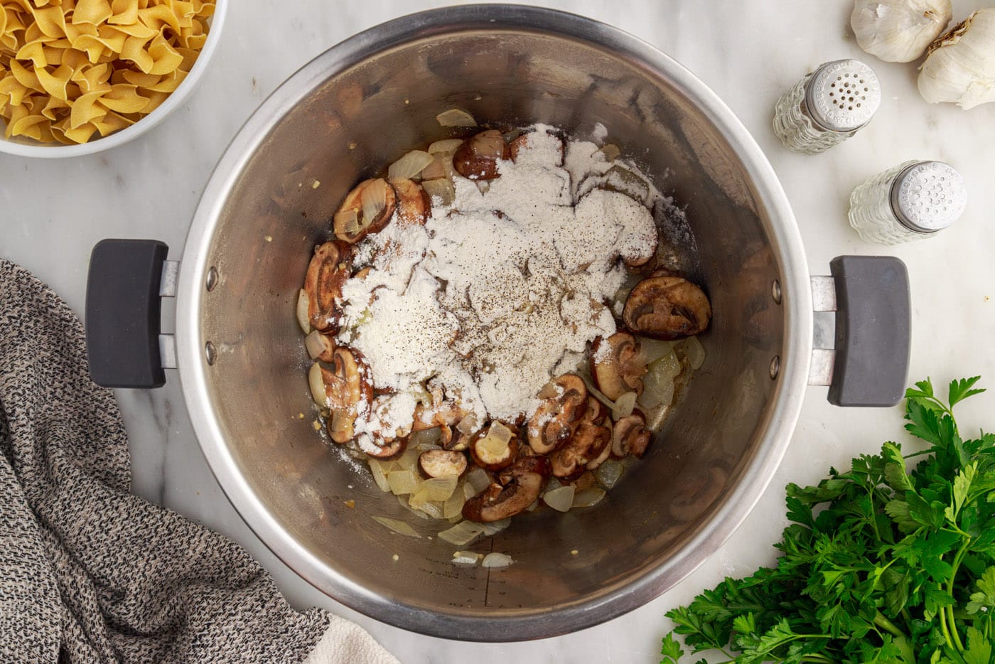 flour over the top of mushrooms and onions in instant pot