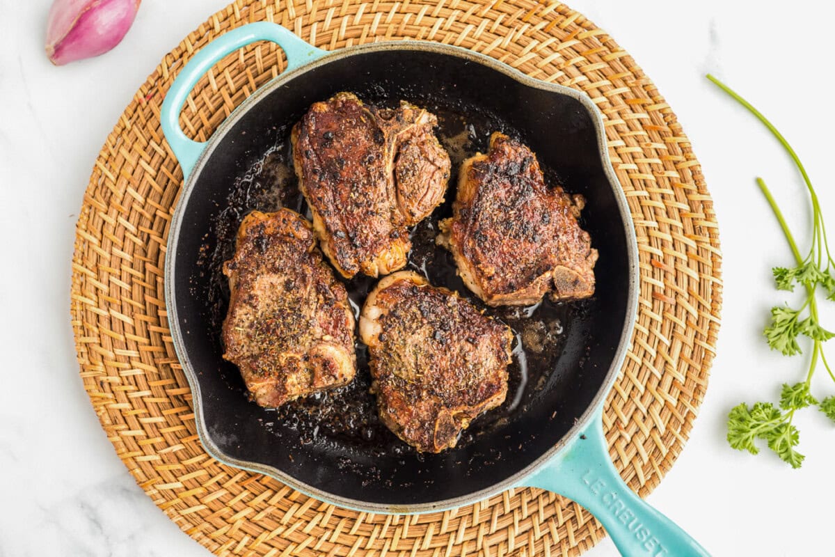 searing lamb chops in a skillet