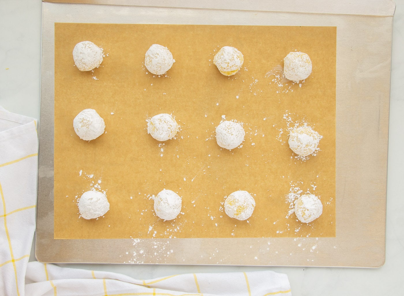 lemon crinkle cookies on a baking sheet