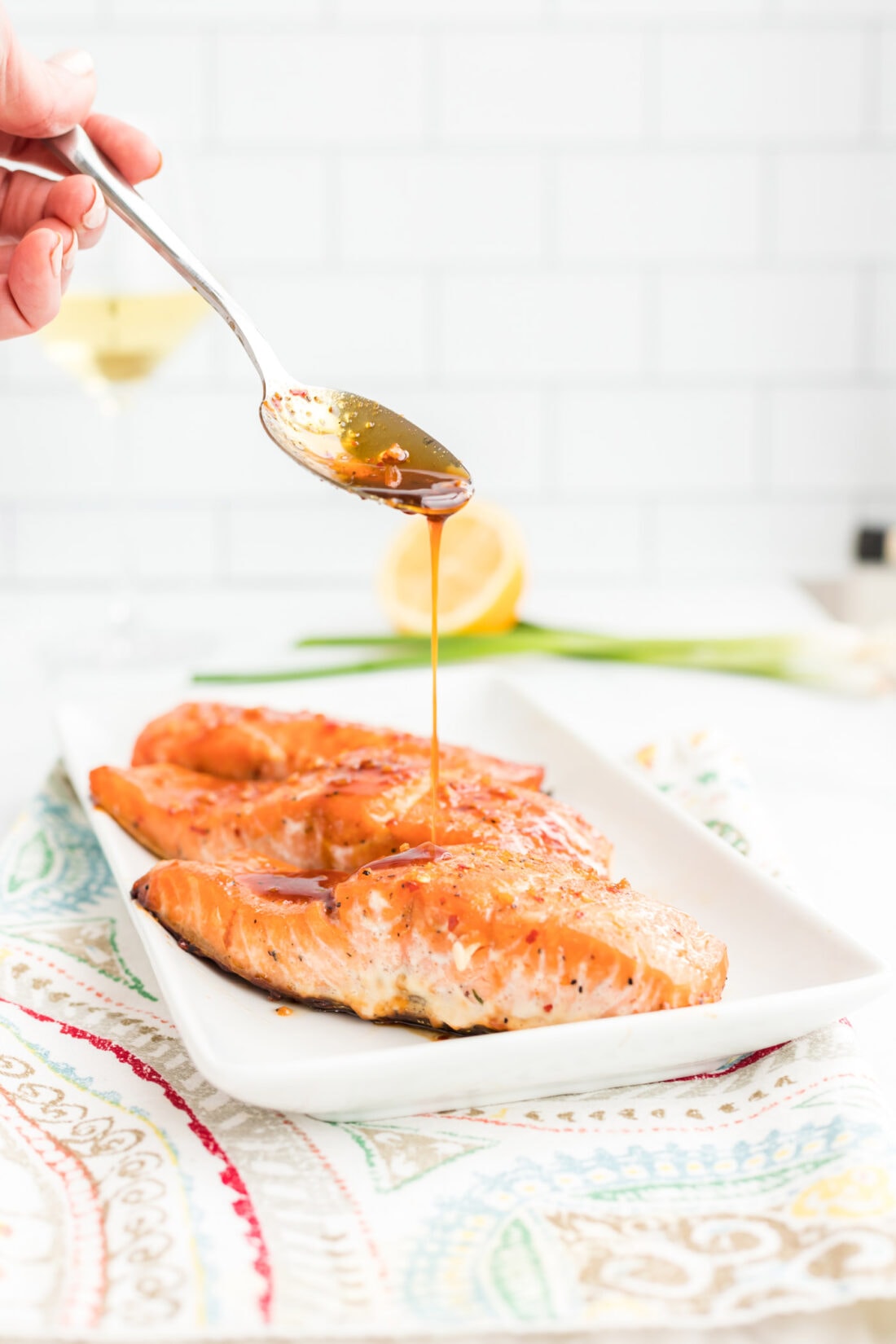 drizzling sauce on Maple Soy Salmon