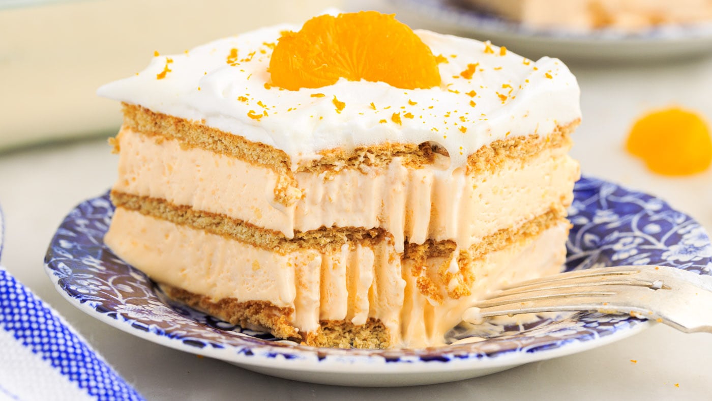 Orange icebox cake is light and creamy, reminiscent of a creamsicle pop. The graham cracker layers s