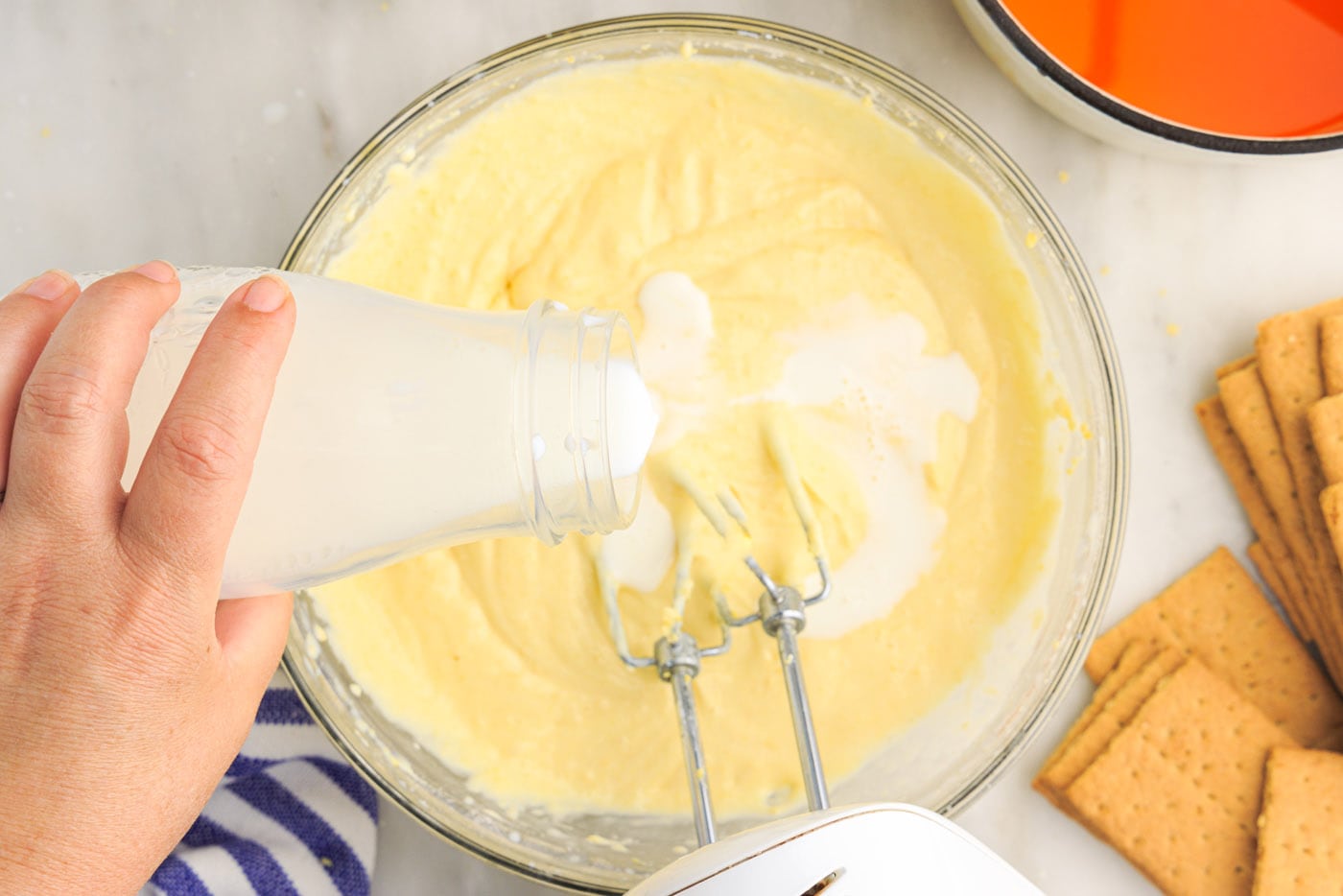 pouring milk into cream cheese mix