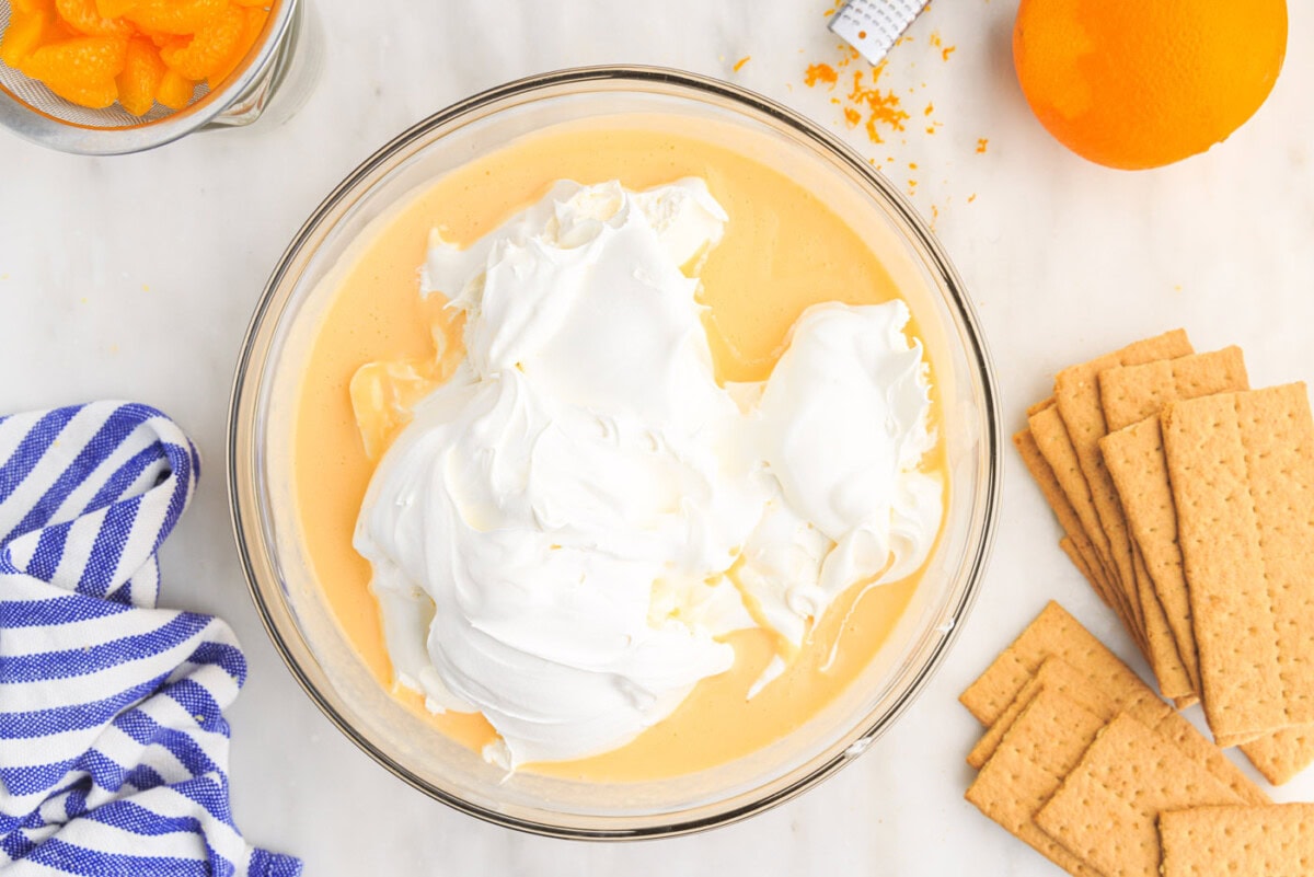 cool whip on top of pudding mix in a bowl