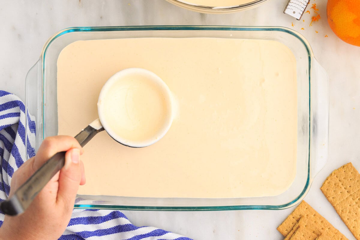 orange pudding mix over graham crackers in baking dish
