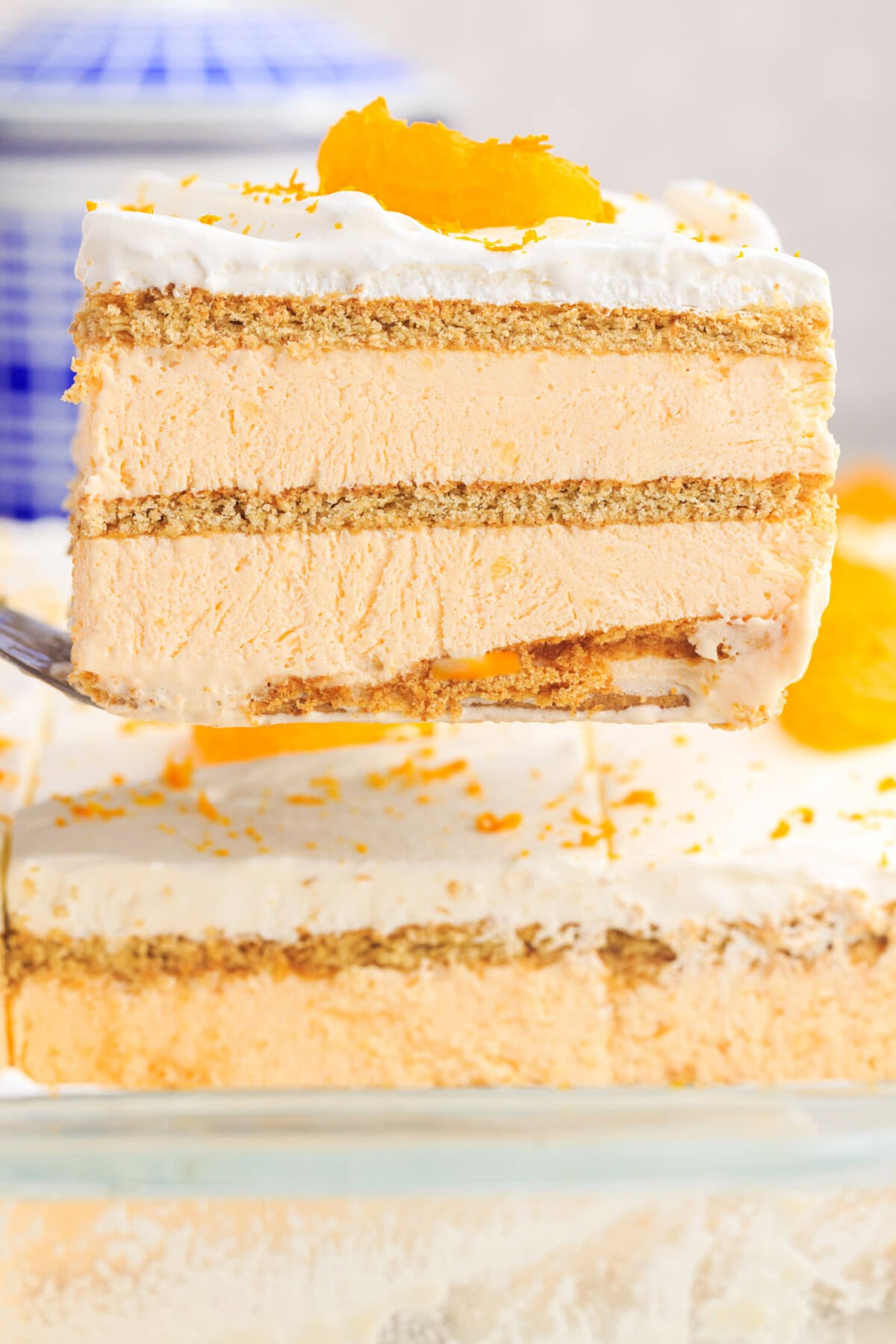 lifting a slice of Orange Icebox Cake with spatula
