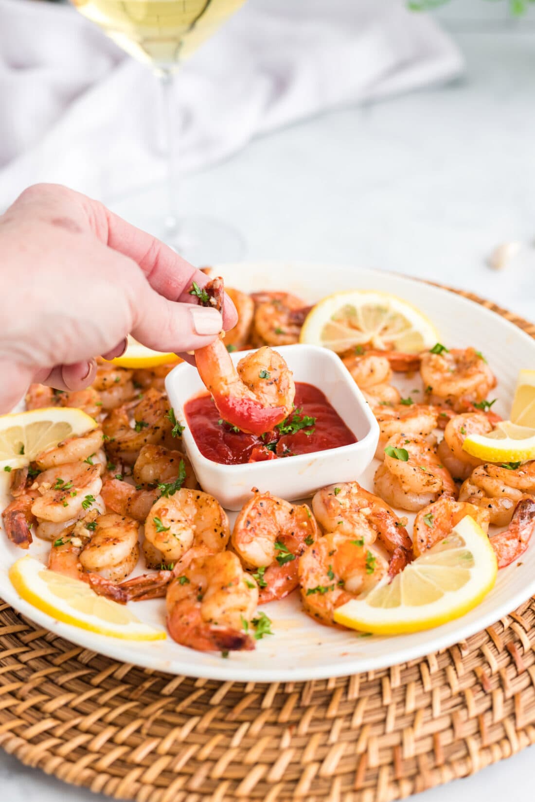 dipping shrimp in cocktail sauce
