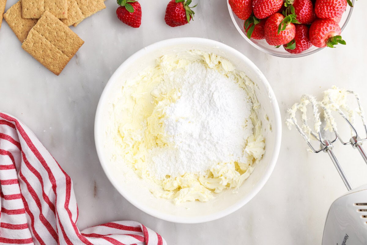cream cheese and powdered sugar in a mixing bowl