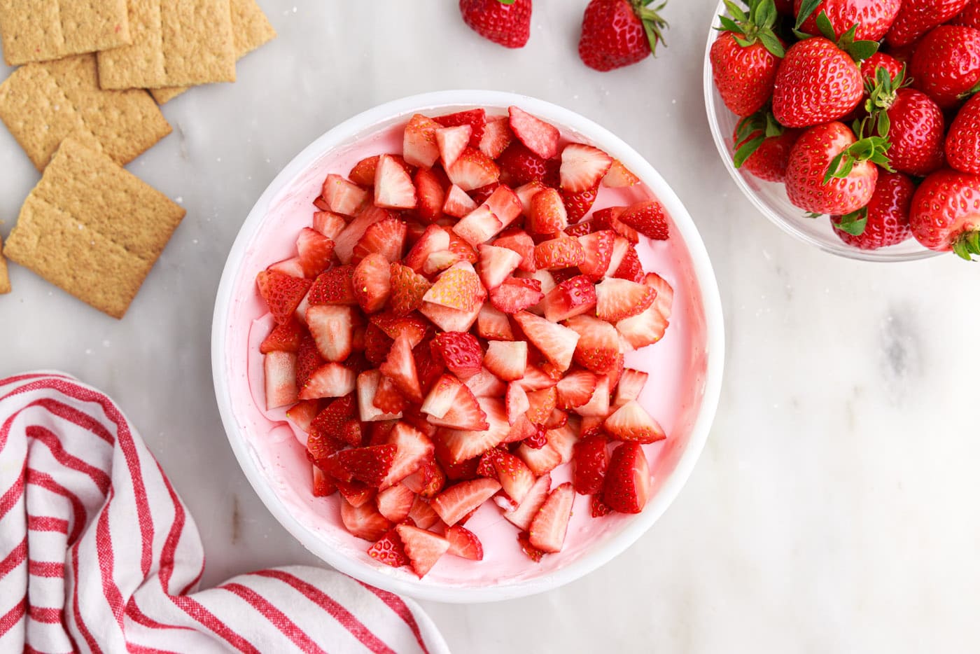 chopped strawberries over strawberry gelatin mixture