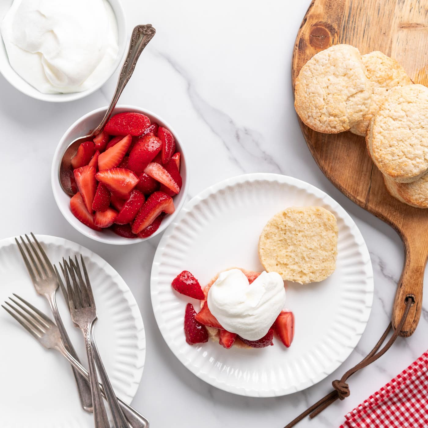 whipped cream on top of strawberries and biscuit