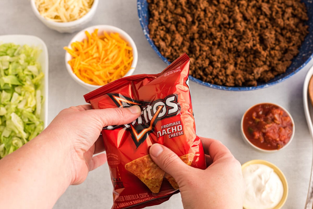 hand crushing bag of chips