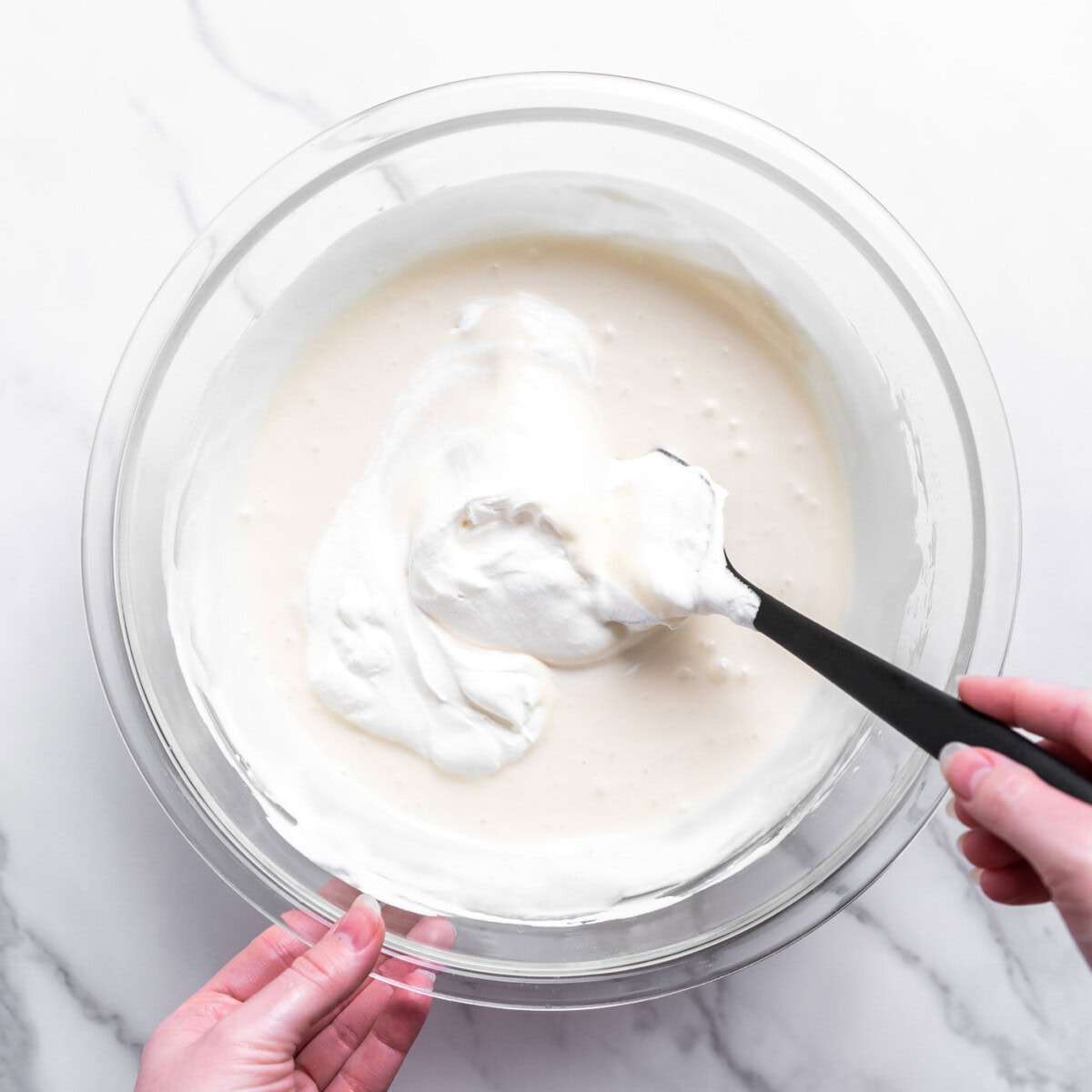 folding together whipped cream and sweetened condensed milk for ice cream