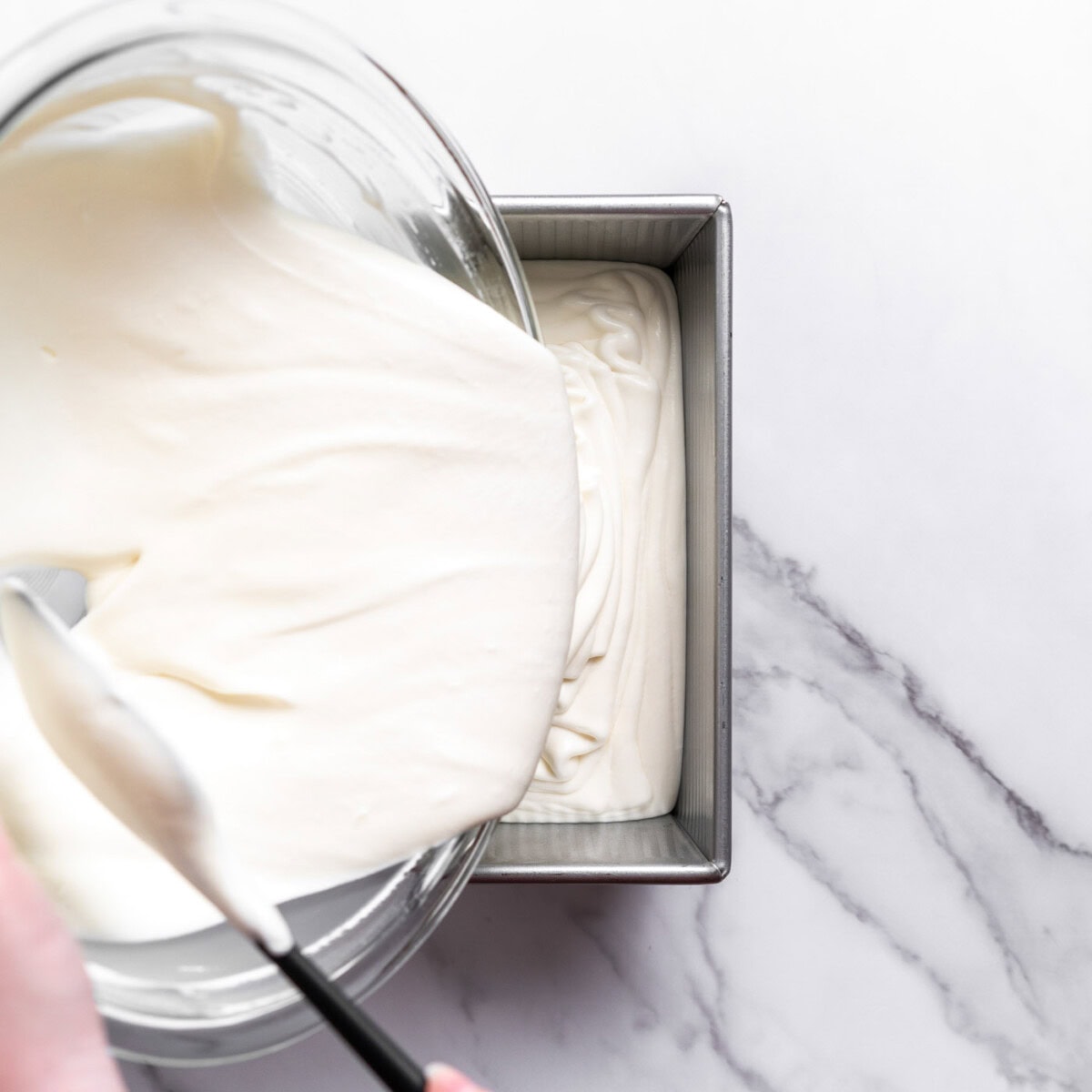 pouring ice cream mixture into a loaf pan