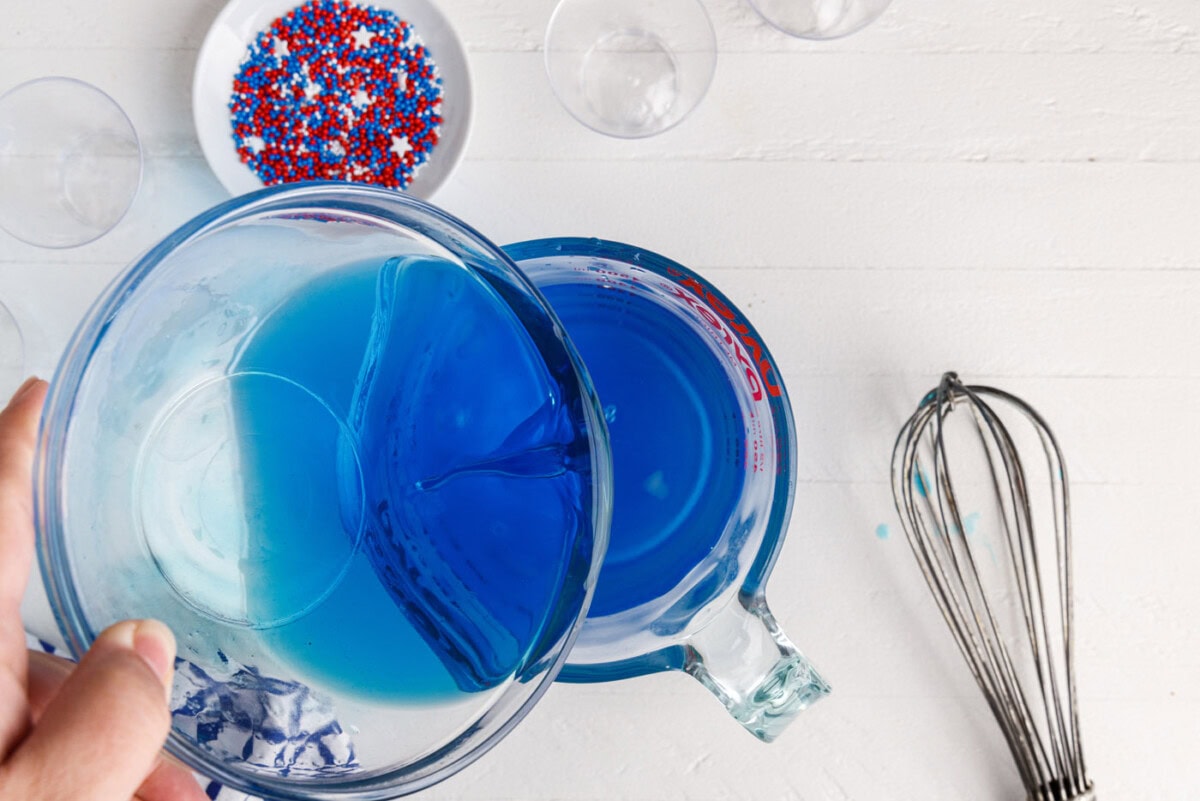 pouring alcohol into blue jello