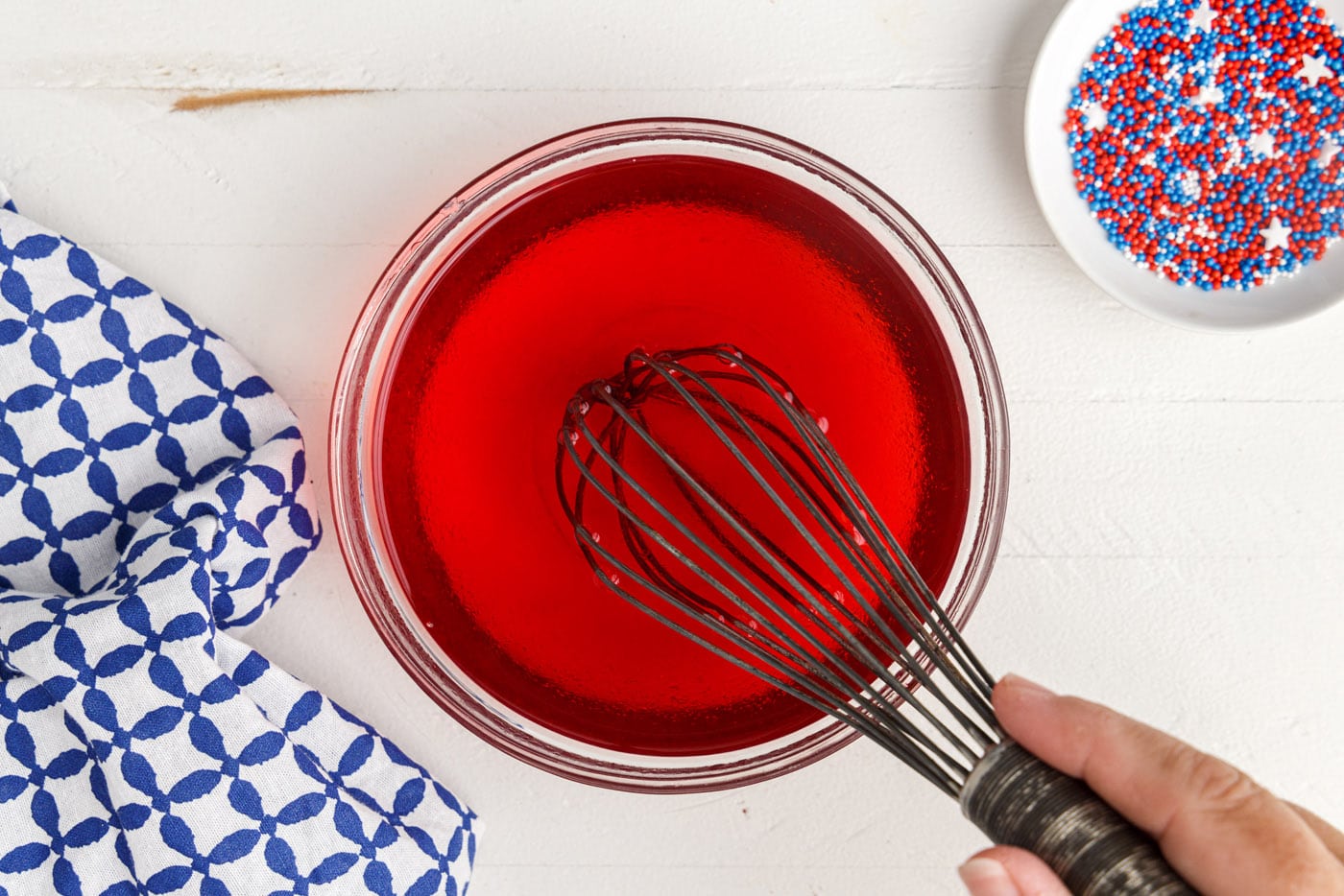 whisking red jello with water