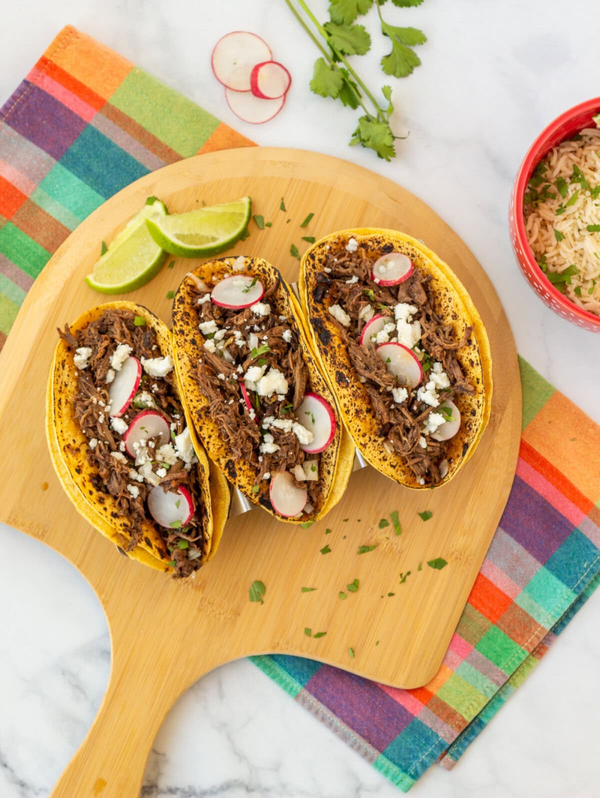 Beef Barbacoa tortillas on a wooden platter