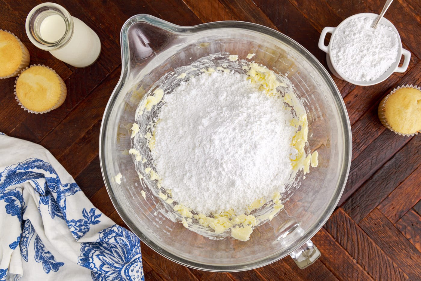 powdered sugar and butter in a mixing bowl