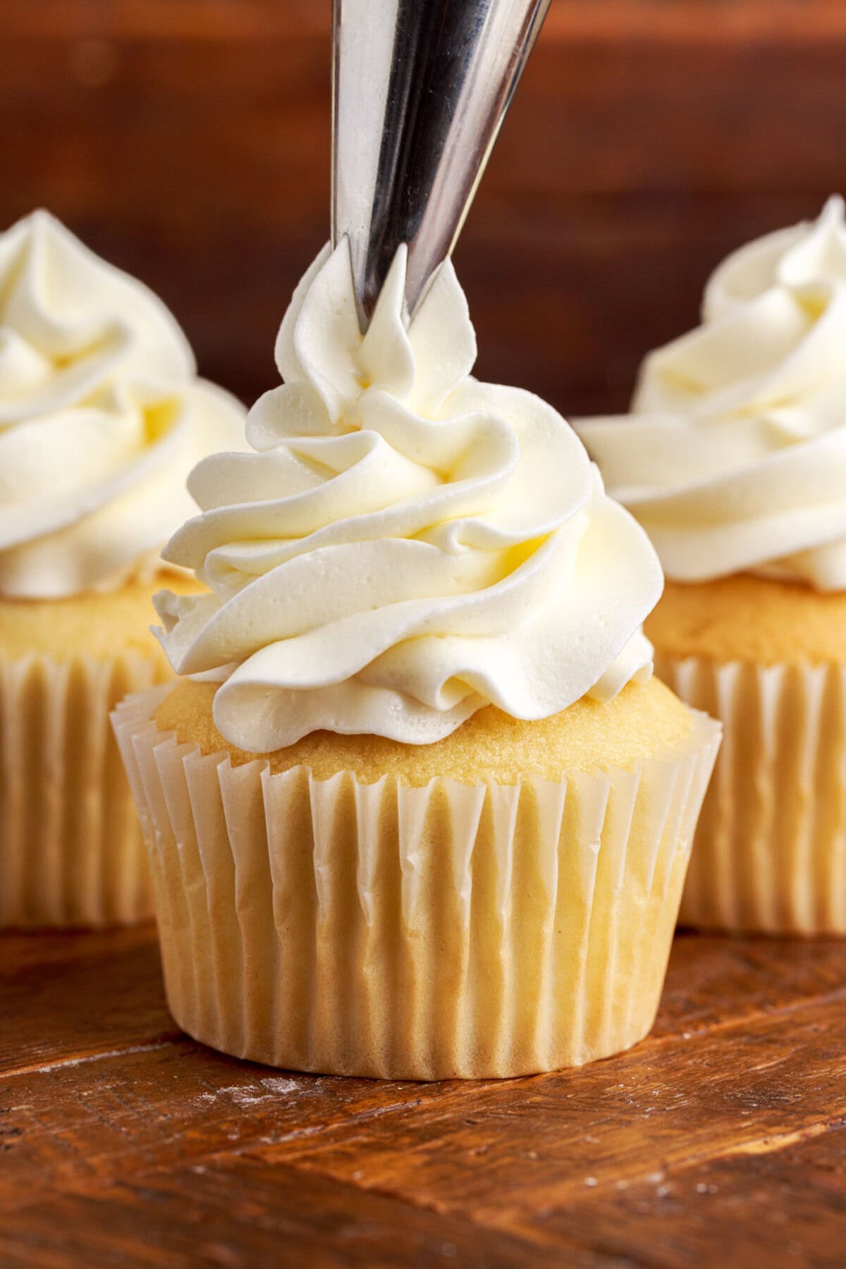 piping Buttercream Frosting onto a cupcake